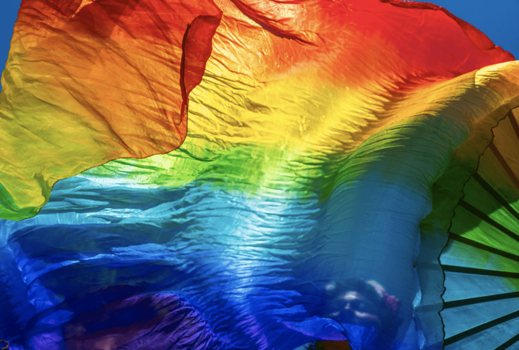 A rainbow flag blows in the wind