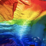 A rainbow flag blows in the wind