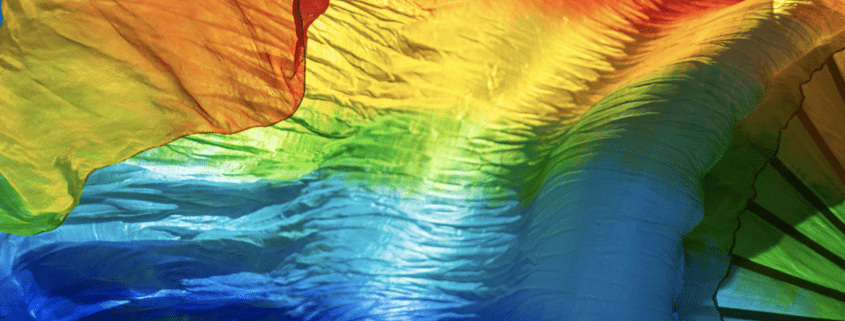 A rainbow flag blows in the wind
